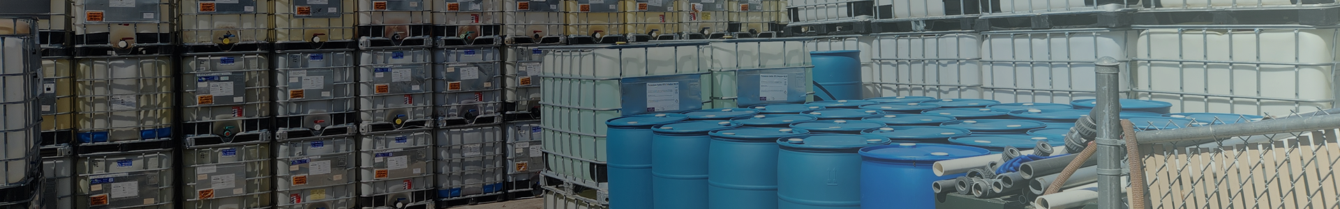 a bunch of blue barrels are stacked on top of each other