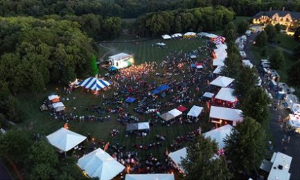 an aerial view of a large field filled with tents and people at a festival