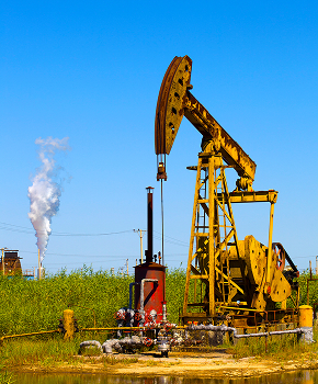 a yellow oil pump with smoke coming out of it