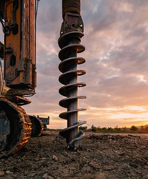 a large spiral drill is being used to dig a hole in the ground