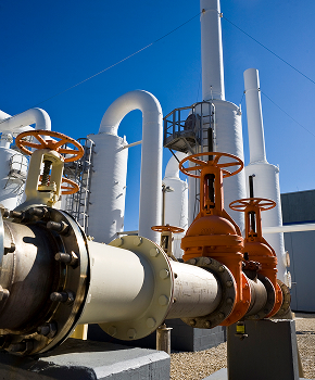 a bunch of pipes with orange valves on them