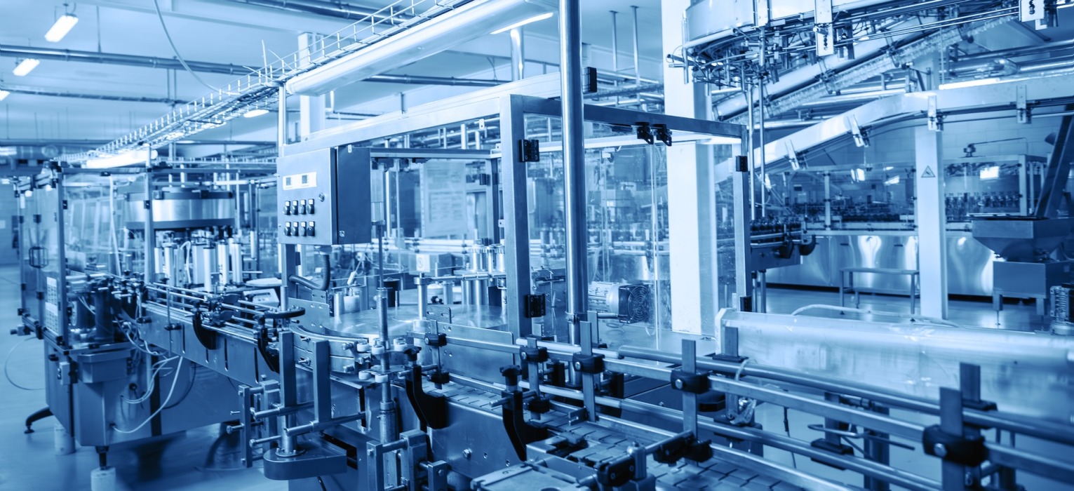 a conveyor belt in a factory with a sign that says ' warning ' on it