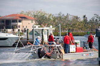 a group of people are on a boat in the water