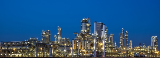 a large oil refinery is lit up at night