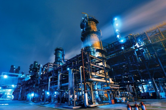 a large industrial plant is lit up at night