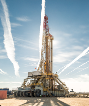 a large oil rig with a blue sky in the background